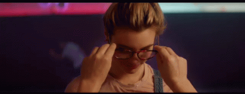 Woman Putting On Glasses And Smiling GIF