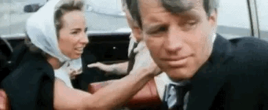 Woman Putting Scarf on Man
