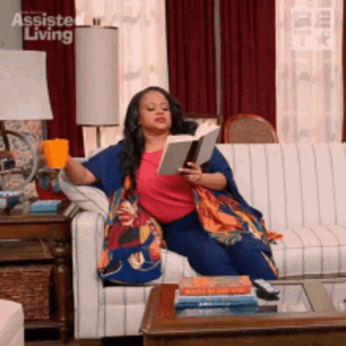 Woman Reading Book On Couch GIF