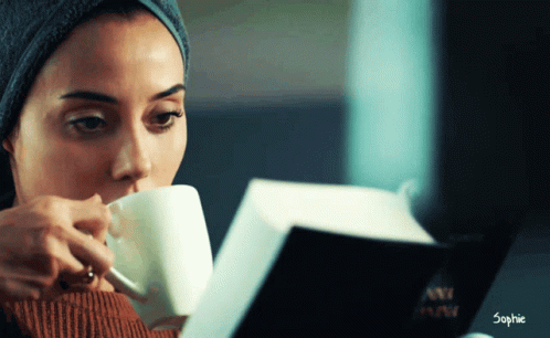 Woman Reading While Drinking The Tea GIF