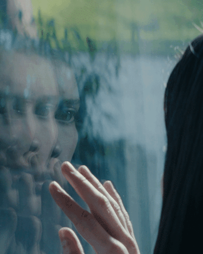 Woman Reflected in Window Touching Glass