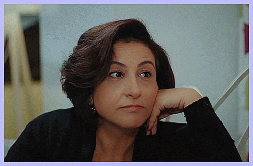 Woman Resting Hand on Chin With Serious Look