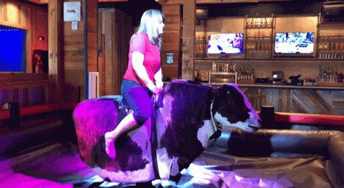 Woman Riding Bull in Bar