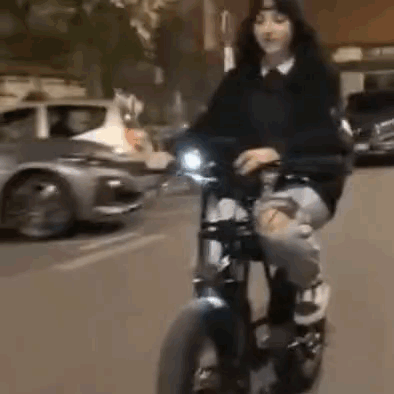 Woman Riding Motorcycle in Front of Car