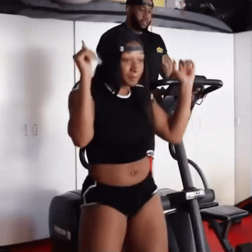 Woman Riding Treadmill Next to Man