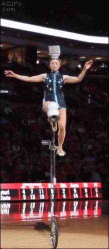 Woman Riding Unicycle With Bucket On Head GIF