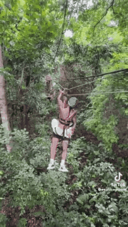 Woman Riding Zip Line in Woods