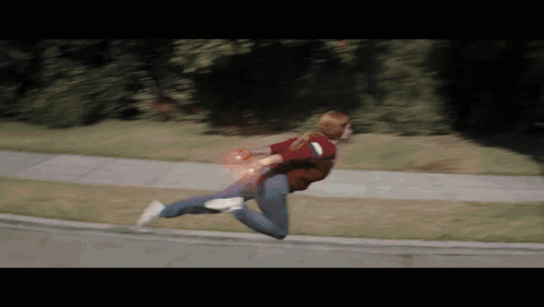 Woman Running Down Sidewalk With Red Light From Hand GIF