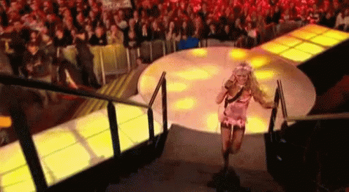 Woman Running Down Stairs in Front of Crowd