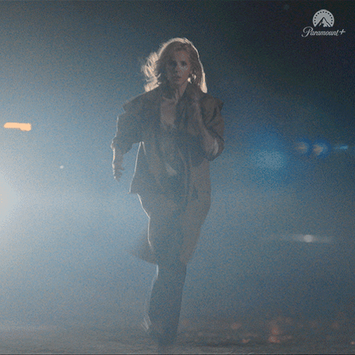Woman Running in Dark Room with Paramount Logo