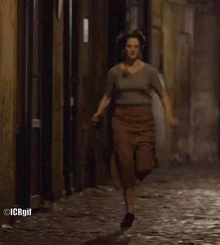 Woman Running On Cobblestone Street GIF