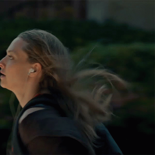 Woman Running With Headphones and Backpack