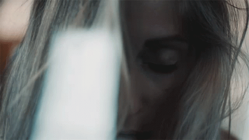 Woman's Face Close Up With Light Behind GIF