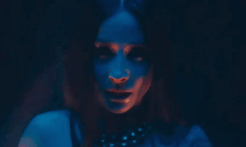 Woman's Face In Dark Room With Red And Blue Lights GIF