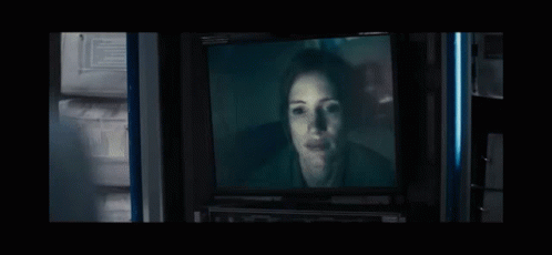 Woman's Face on TV in Dark Room