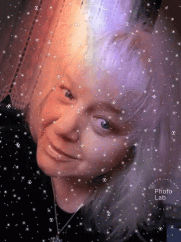 Woman's Face Surrounded By Snowflakes GIF