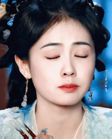 Woman's Face with Earrings and Eyes Closed