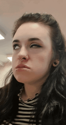 Woman's Face With Nose Ring and Piercings