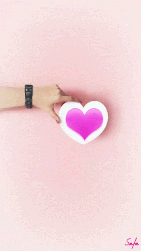 Woman's Hand Holding Pink Heart