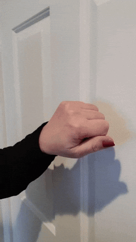Woman's Hand with Red Nails Holding Door