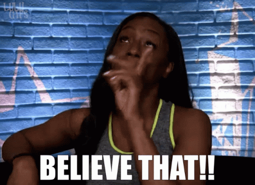 Woman Saying Believe in Front of Blue Wall