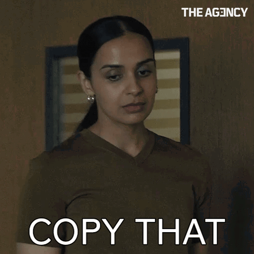 Woman Saying Copy That in Front of Wall