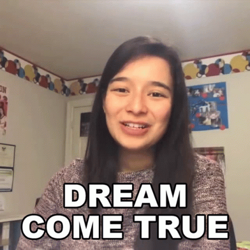 Woman Saying Dream Come True In Front Of Picture Wall GIF