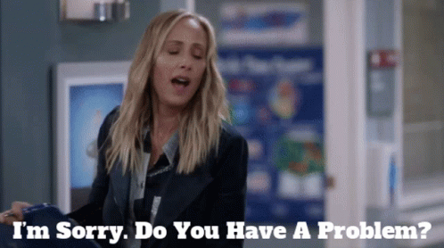 Woman Saying I'm Sorry Do You Have A Problem In Front of Sign