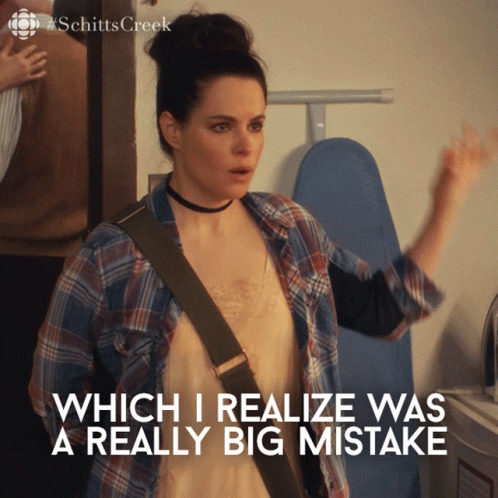 Woman Saying Which I Realize Was a Really Big Mistake in Front of Ironing Board
