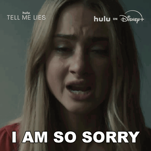 Woman Says I Am So Sorry in Front of Tell Me Lies Sign