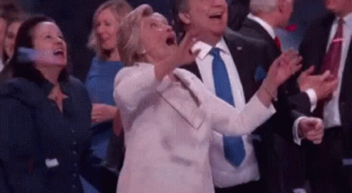 Woman Screaming In Crowd While Man In Suit Claps GIF
