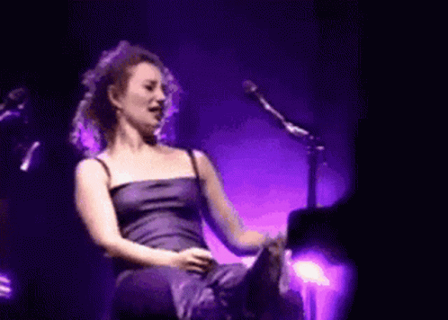 Woman Singing in Purple Dress