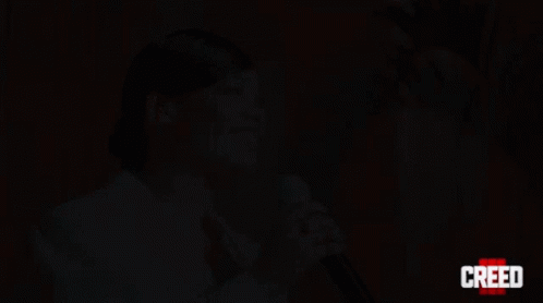 Woman Singing Into Microphone Creed