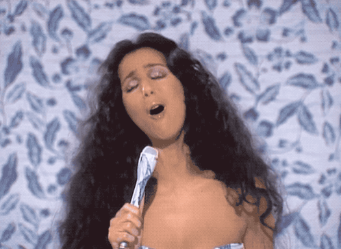 Woman Singing Into Microphone Eyes Closed