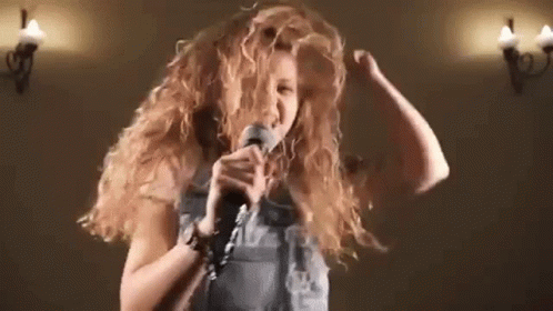 Woman Singing Into Microphone