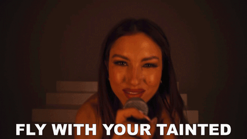 Woman Singing Into Microphone Fly With Your Tainted
