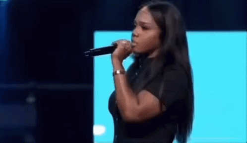 Woman Singing Into Microphone