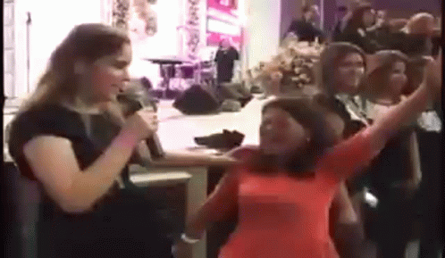Woman Singing Into Microphone in Church, People Dancing