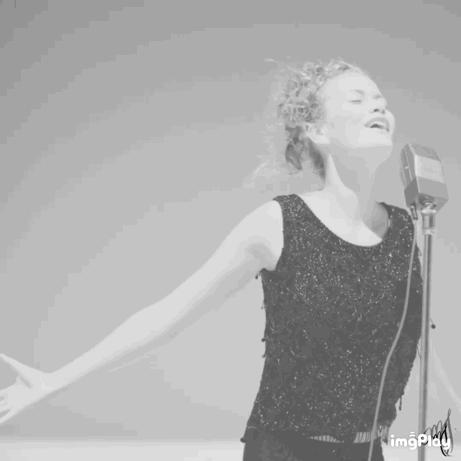 Woman Singing Into Microphone