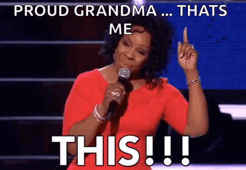 Woman Singing Into Microphone Saying Proud Grandma That's Me
