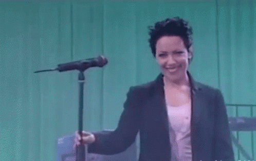 Woman Singing Into Microphone Smiling