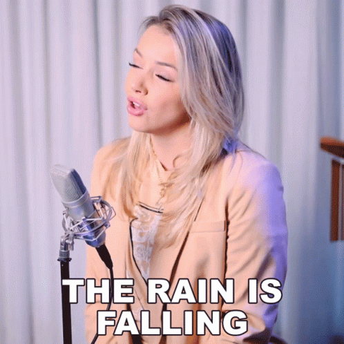 Woman Singing Into Microphone The Rain Is Falling