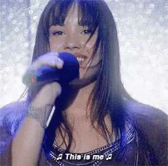Woman Singing Into Microphone This Is Me