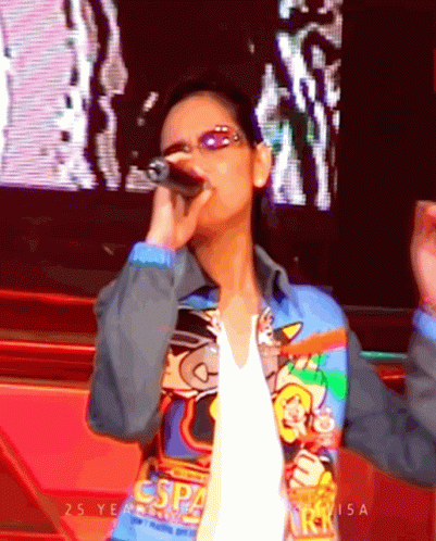 Woman Singing Into Microphone Wearing ESP4 Jacket GIF