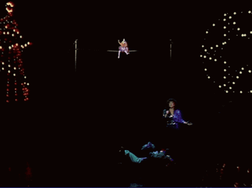 Woman Singing Into Microphone With Christmas Tree GIF