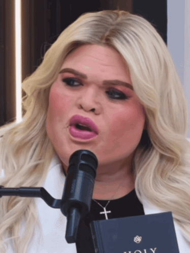 Woman Singing Into Microphone With Holy Book GIF