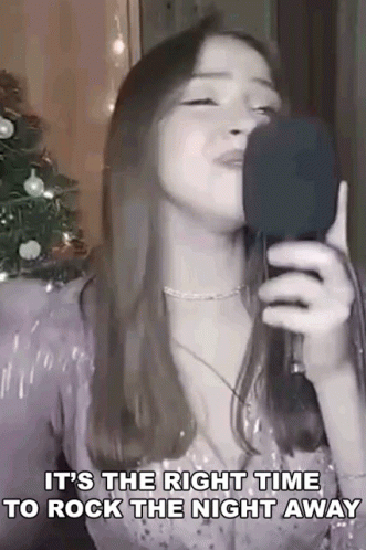 Woman Singing Into Microphone with Lyrics