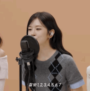 Woman Singing Into Microphone With Numbers 1 Through 7