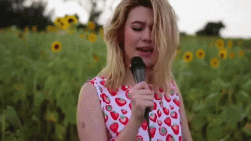 Woman Singing Into Microphone With Strawberries GIF