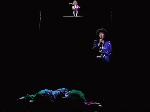 Woman Singing Into Microphone With Two Clowns GIF